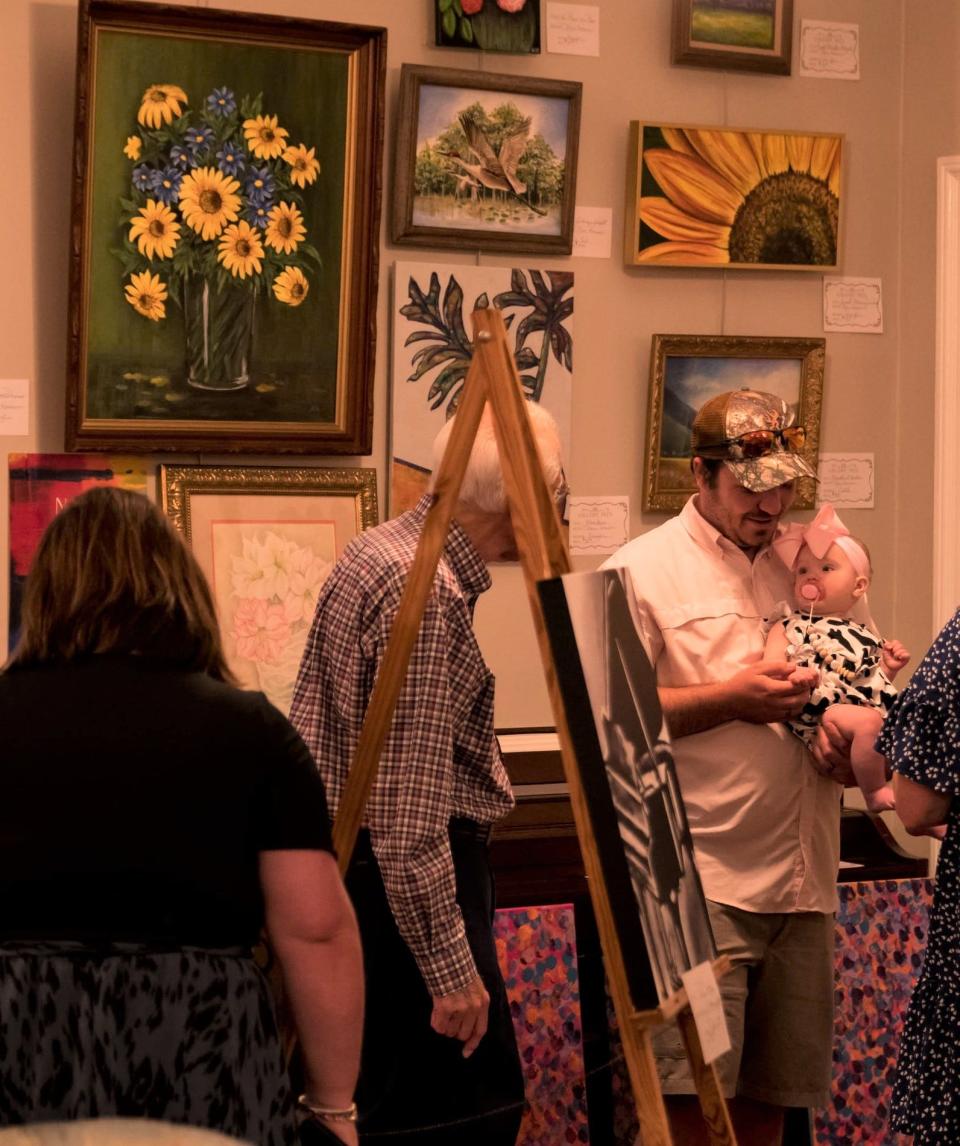 Citizens and artists gathered and strolled through the exhibits during the opening of the arts guild's Spring show at Gallery 1923.