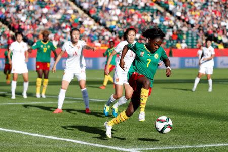 Jun 20, 2015; Edmonton, Alberta, CAN; Cameroon forward Gabrielle Onguene (7) controls the ball against China during the second half in the round of sixteen in the FIFA 2015 women's World Cup soccer tournament at Commonwealth Stadium. Mandatory Credit: Erich Schlegel-USA TODAY Sports