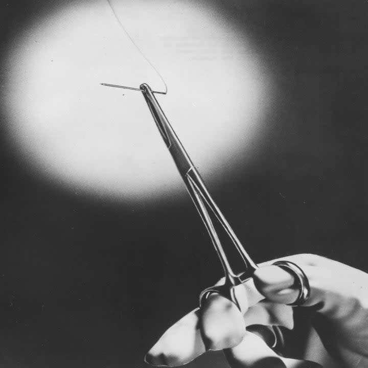 A rendering of a hand holding a surgical device