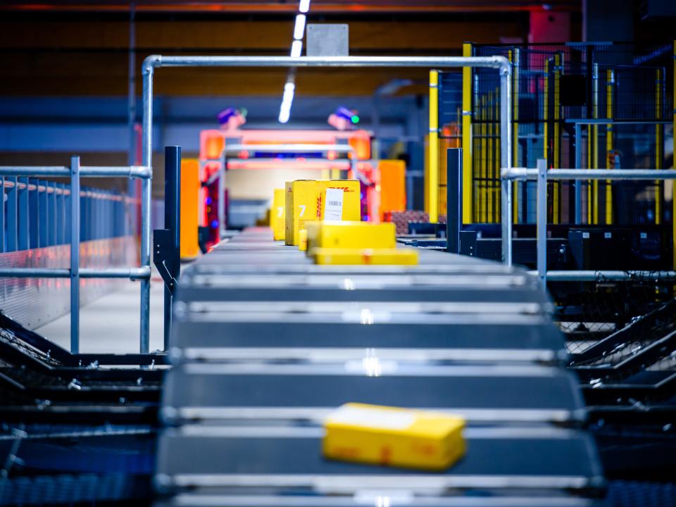 A DHL parcel center where packages move across a conveyor belt