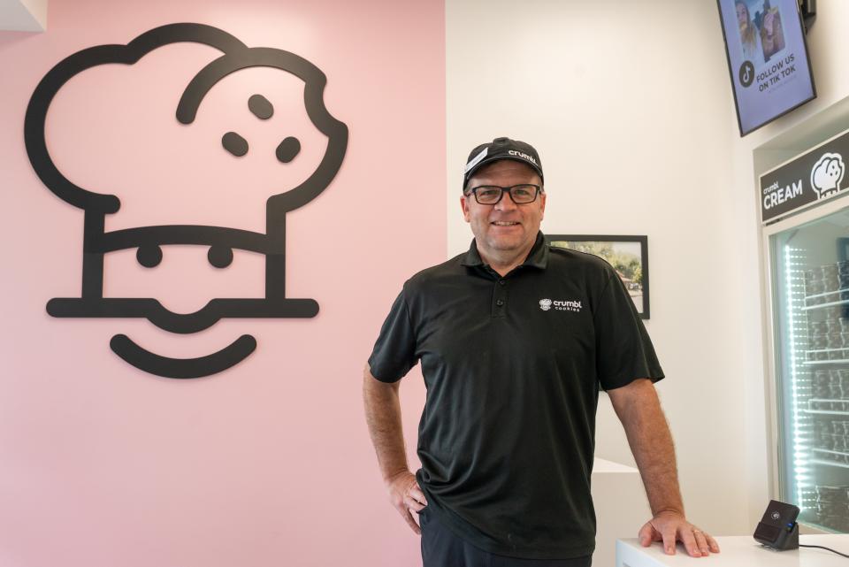 Darren Haddock, chief operating officer for Crumbl Cookies, stands by the checkout counter inside its new Topeka location Monday morning. The business, which sells a selection of cookies that rotate each week, will open Thursday.