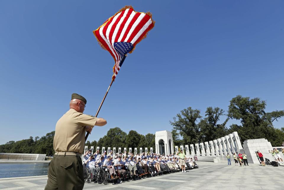 A flag bearer marches toward veterans of the Chicago Honor Flight at the World War Two Memorial in Washington October 2, 2013. The memorial is technically closed due to the government shutdown, but was opened today and yesterday for visiting veteran groups REUTERS/Kevin Lamarque (UNITED STATES - Tags: POLITICS BUSINESS)