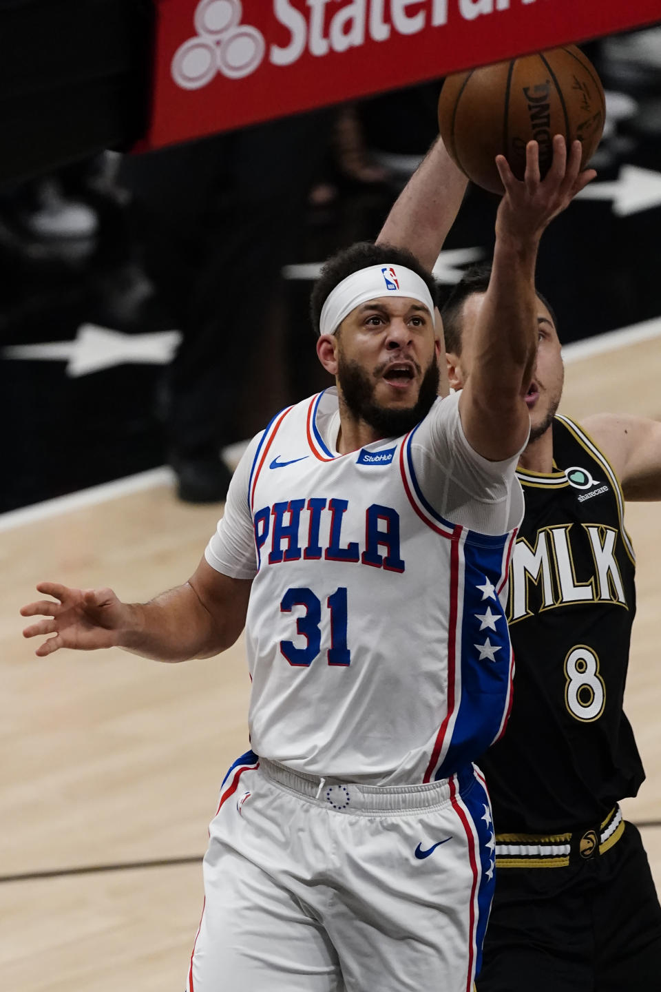 Philadelphia 76ers guard Seth Curry (31) drives to the basket as Atlanta Hawks forward Danilo Gallinari (8) defends during the first half of Game 6 of an NBA basketball Eastern Conference semifinal series Friday, June 18, 2021, in Atlanta. (AP Photo/John Bazemore)