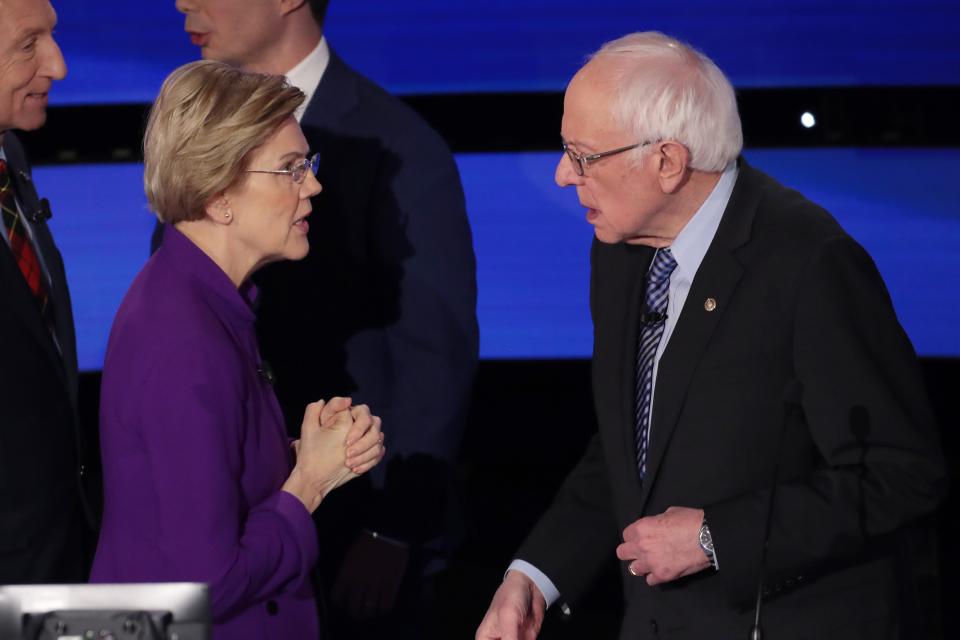 Sens. Elizabeth Warren and Bernie Sanders at the presidential debate on Jan. 14, 2020, in Des Moines, Iowa.