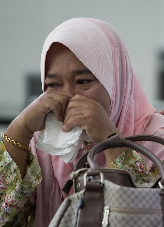 A relative of passengers from the missing Malaysia Airlines Boeing 777-200 plane cries while awaiting updates at a hotel in Putrajaya, on March 11, 2014