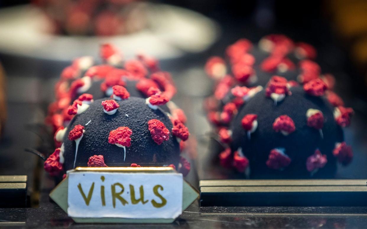 A dessert in the shape of a coronavirus, spike proteins and all, placed in a window of a coffee shop in Prague - Gabriel Kuchta/Getty Images