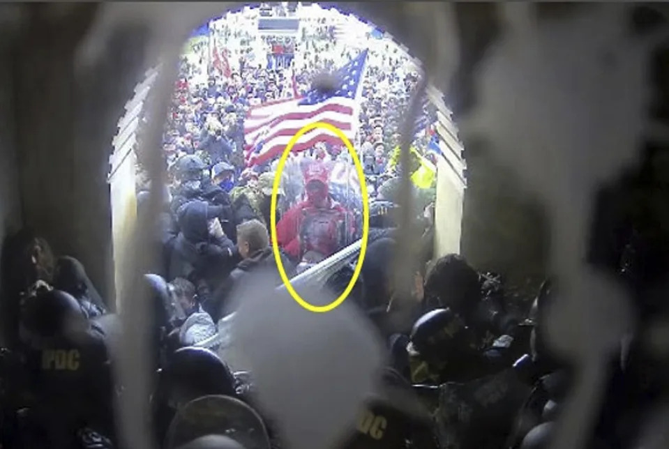 This image from police body-worn video and contained in the Justice Department statement of facts supporting the arrest of Rally Runner, a St. Louis Cardinals superfan who legally changed his name from Daniel Donnelly Jr., shows Rally Runner outside the U.S. Capitol on Jan. 6, 2021, in Washington. (Department of Justice via AP)