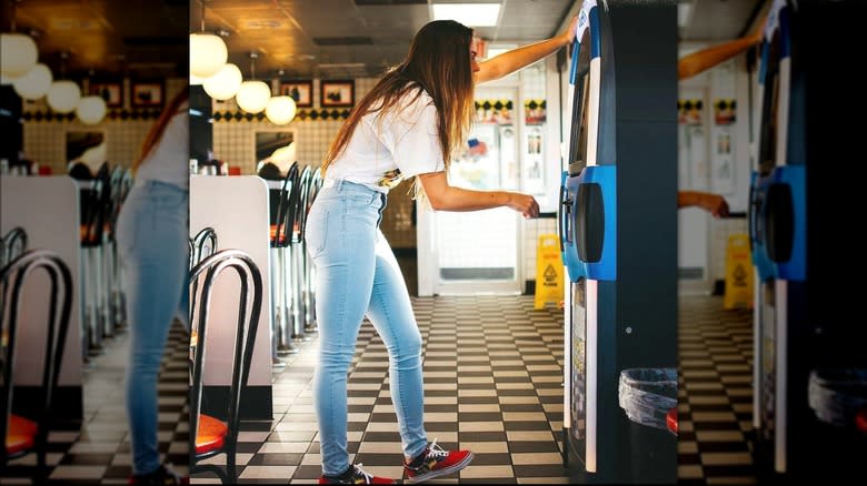 woman standing by jukebox