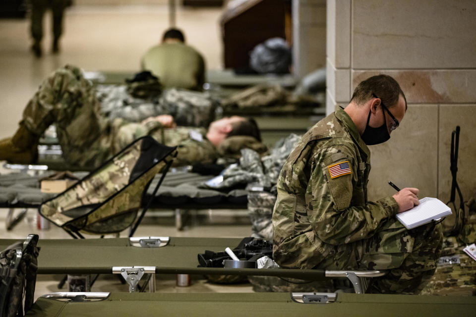 National Guard soldiers rest on cots in the Visitors Center of the U.S. Capitol on January 17, 2021 in Washington, DC.  / Credit: Samuel Corum / Getty Images