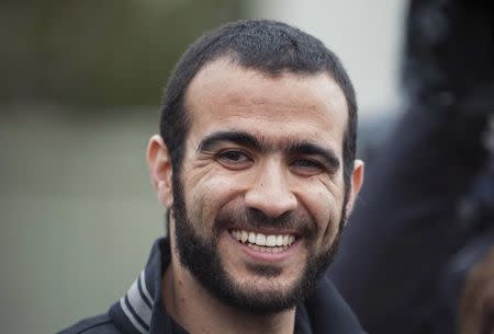 Omar Khadr smiles as he answers questions during a news conference after being released on bail in Edmonton, Alberta, Canada, May 7, 2015. REUTERS/Dan Riedlhuber/File photo