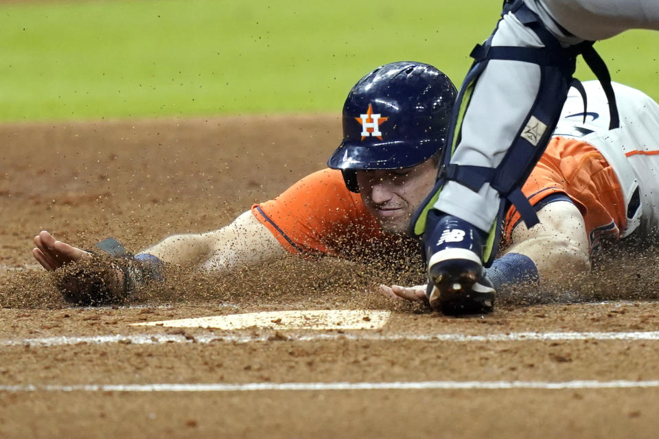 Houston Astros' Kyle Tucker scores during the first inning of a baseball game against the Seattle Mariners Friday, Aug. 14, 2020, in Houston. (AP Photo/David J. Phillip)