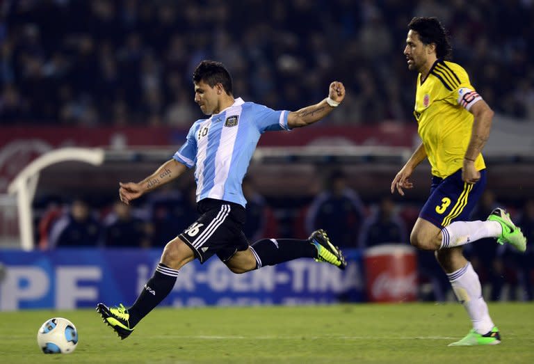 Argentina's Sergio Aguero lines up a shot in front of Colombia's Mario Yepes during their FIFA World Cup Brazil 2014 qualifying match at Monumental stadium in Buenos Aires on June 7, 2013. The match ended 0-0