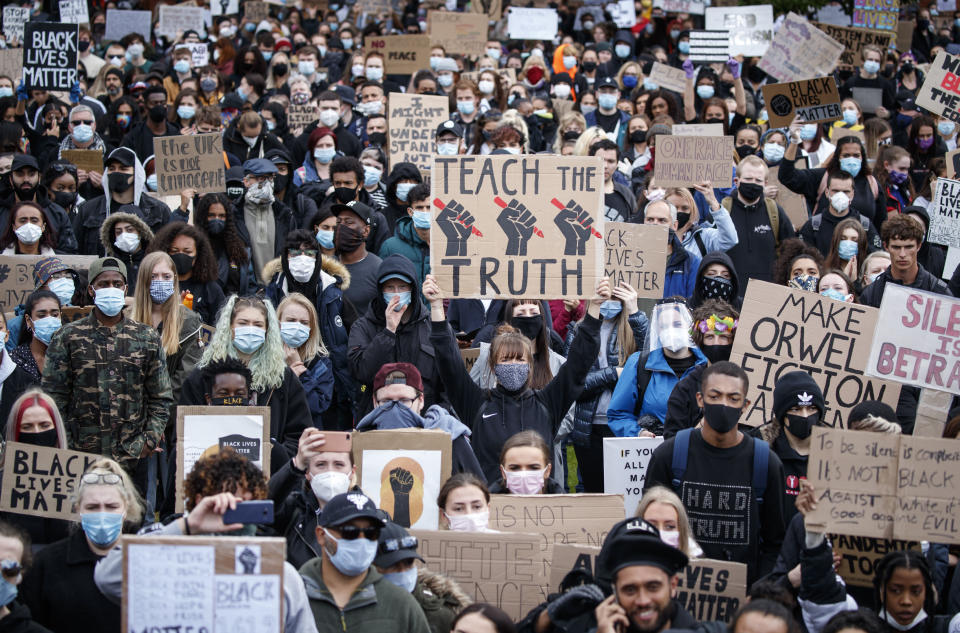 People take part in a Black Lives Matter protest rally in Piccadilly Gardens, Manchester, England, Saturday, June 6, 2020, after the recent killing of George Floyd by police officers in Minneapolis, USA, that has led to protests in many countries and across the US. (Danny Lawson/PA via AP)