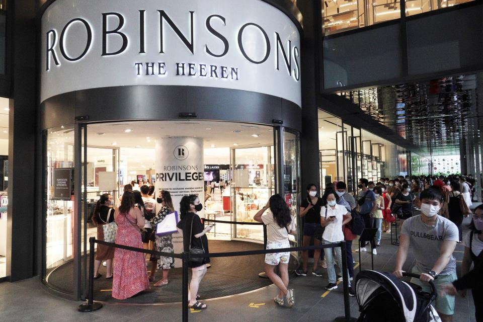 SINGAPORE, Oct. 30, 2020 -- Shoppers queue to enter the Robinsons department store at Heeren in Singapore on Oct. 30, 2020. The 162-year-old Robinsons announced the closing of its last 2 stores in Singapore, and will be exiting the retail scene. (Photo by Then Chih Wey/Xinhua via Getty) (Xinhua/Then Chih Wey via Getty Images)