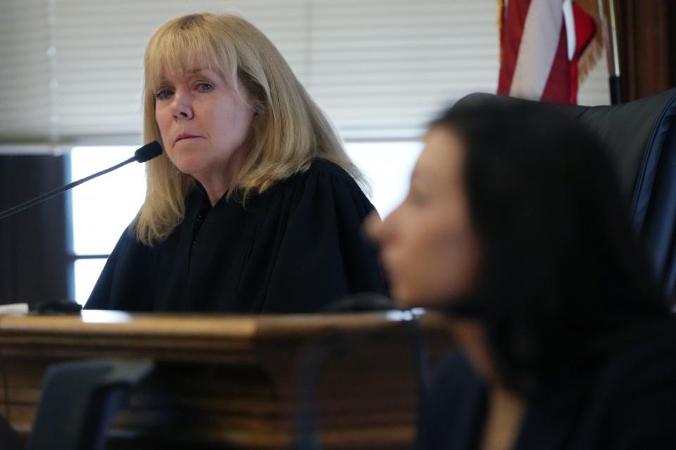 Judge Beverly J. Cannone, left, listens to testimony from Katie McLaughlin during Karen Read's murder trial, Friday, May 3, 2024, in Dedham, Mass. Read is accused of backing her SUV into her Boston Police officer boyfriend, John O'Keefe, and leaving him to die in a blizzard in Canton, Mass., in 2022. (AP Photo/Michael Dwyer, Pool)