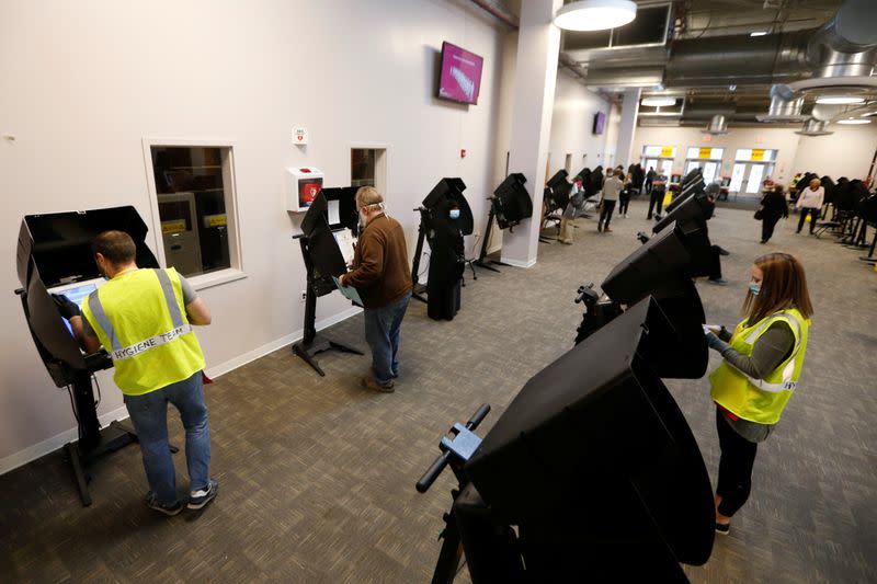 Voters line up to cast their ballots for the presidential primary elections in Columbus