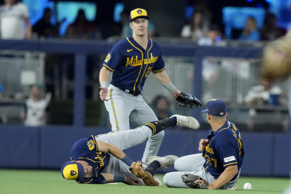 Milwaukee Brewers center fielder Sal Frelick, left, cannot make a play on a ball hit by Miami Marlins' Xavier Edwards for a single during the fourth inning of a baseball game, Sunday, Sept. 24, 2023, in Miami. (AP Photo/Lynne Sladky)