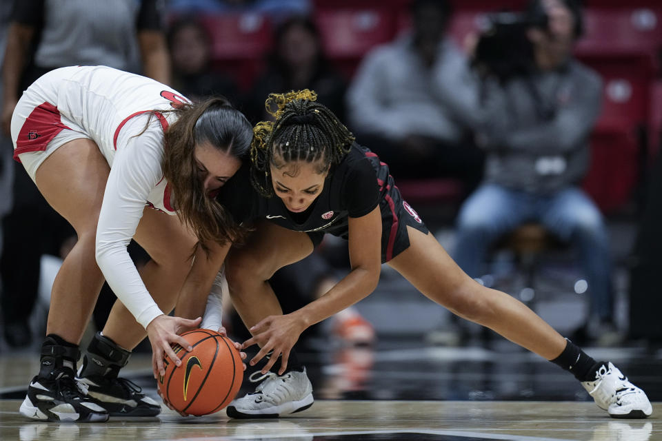 Stanford guard Jzaniya Harriel, right, battles San Diego State guard Meghan Fiso for the ball during the first half of an NCAA college basketball game, Friday, Dec. 1, 2023, in San Diego. (AP Photo/Gregory Bull)