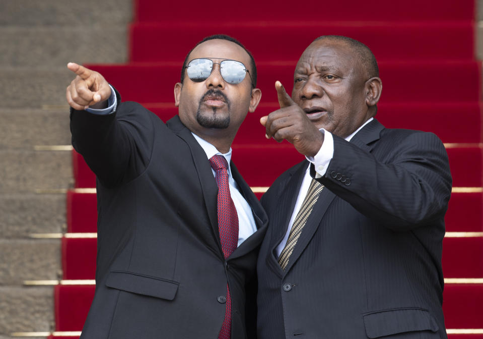 South African President Cyril Ramaphosa, left, with Ethiopia's Prime Minister Abiy Ahmed gestures as they pose for a photo prior to their talks at the Union Building in Pretoria, South Africa, Sunday, Jan. 12, 2020. (AP Photo/Themba Hadebe)