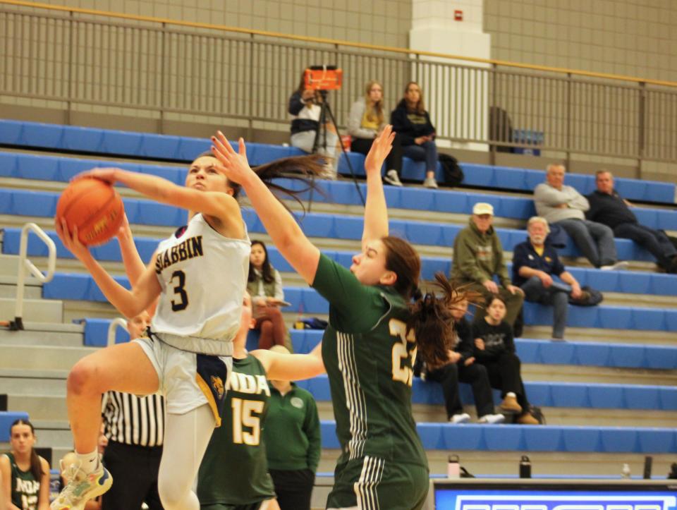Meaghan Doyle of Quabbin goes up hard for a shot against NDA defenders in the CMADA final on February 21, 2024.