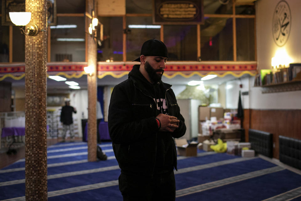 Mohammed Widdi, 31, coordinator of Muslims Giving Back, prays at the Muslim Community Center between volunteering on Monday, April 27, 2020, in the Brooklyn borough of New York. For Widdi and a group of Brooklyn Muslims, the holy month of Ramadan is a blur: They fast during daylight hours, pray repeatedly, and use every bit of their remaining energy to feed the hungry. (AP Photo/Wong Maye-E)