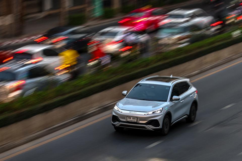 A BYD Atto 3 driving down a road.