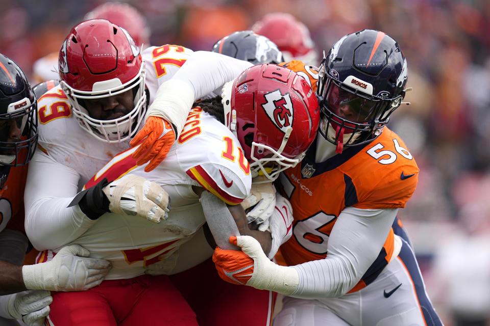 Kansas City Chiefs running back Isiah Pacheco (10) is stopped by Denver Broncos linebacker Baron Browning (56) as Chiefs tackle Donovan Smith (79) defends during the first half of an NFL football game Sunday, Oct. 29, 2023, in Denver. (AP Photo/Jack Dempsey)