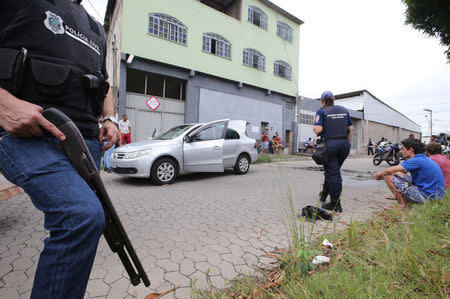 Police officers patrol the perimeter at the scene of a fatal shooting in Vila Velha, Espirito Santo, Brazil February 9, 2017. REUTERS/Paulo Whitaker