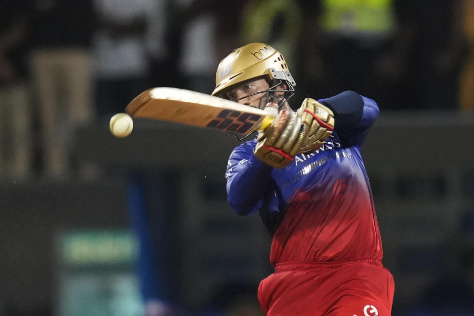 Royal Challengers Bengaluru's Dinesh Karthik plays a shot during Indian Premier League cricket match between Mumbai Indians and Royal Challengers Bangaluru, in Mumbai, India, Thursday, April 11, 2024. (AP Photo/Rajanish Kakade)