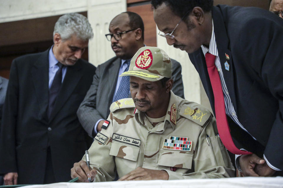 FILE- Gen. Mohammed Hamdan Dagalo signs a power sharing document with Sudan's pro-democracy movement and the ruling military council in Khartoum, Sudan, Wednesday, July 17, 2019. Sudan’s warring generals Gen. Abdel-Fattah Burhan and Gen. Mohammed Hamdan Dagalo, agreed to hold a face-to-face meeting as part of efforts to establish a cease-fire and initiate political talks to end the country’s devastating war, an African regional bloc said Sunday, Dec 10, 2023. (AP Photo/Mahmoud Hjaj, file)