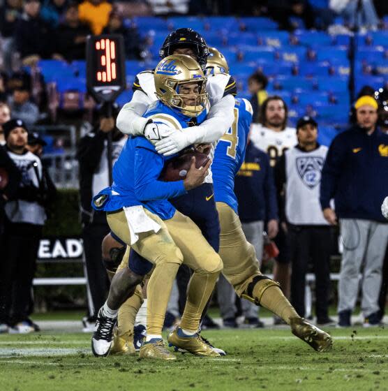 UCLA quarterback Dante Moore is sacked by Cal linebacker David Reese late in the fourth quarter