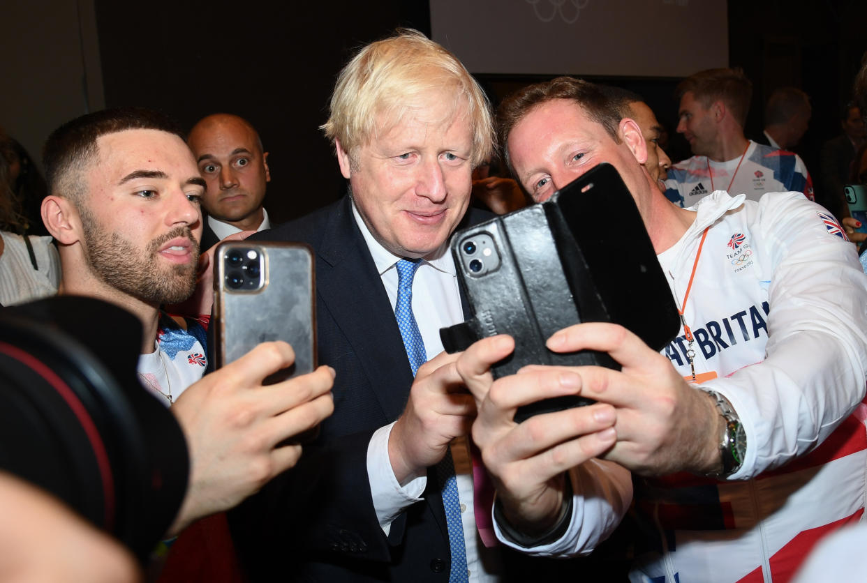 LONDON, ENGLAND - AUGUST 15: Prime Minister, Boris Johnson poses with Oliver Townend and other olympians during The National Lottery's Team GB homecoming event at Hilton London Wembley on August 15, 2021 in London, England. (Photo by Gareth Cattermole/Getty Images for The National Lottery)