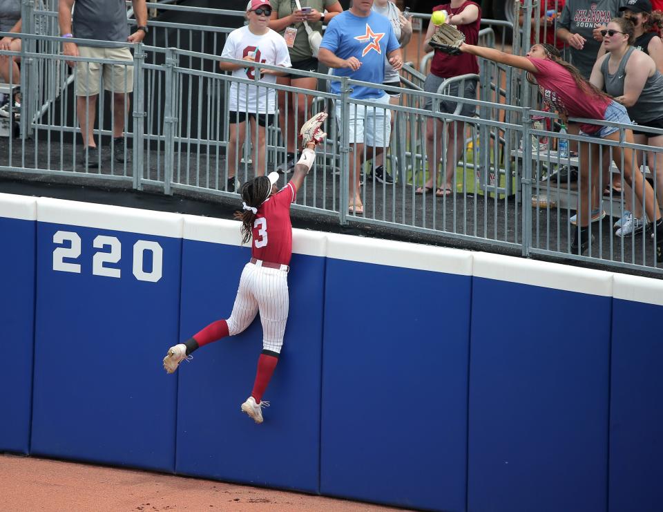Alabama's Kristen White (3) leaps as the ball goes over the wall for a home run in the third inning of a softball game between Tennessee and Alabama in the Women's College World Series at USA Softball Hall of Fame Stadium in Oklahoma City, Thursday, June 1, 2023. 