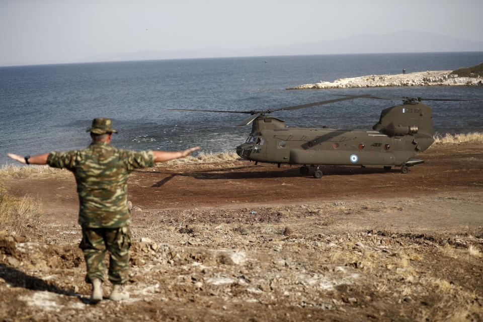A Greek Army helicopter carrying the European Council President Charles Michel lands in the new temporary refugee camp in Kara Tepe on the northeastern island of Lesbos, Greece, Tuesday, Sept. 15, 2020. Greece has called on the European Union to jointly run new refugee camps being built on its eastern islands as part of a planned overhaul of the bloc's migration policy. (Dimitris Tosidis/Pool via AP)