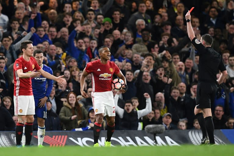 English referee Michael Oliver (R) shows a red card to Manchester United's midfielder Ander Herrera (L) during their English FA Cup match against Chelsea in London on March 13, 2017