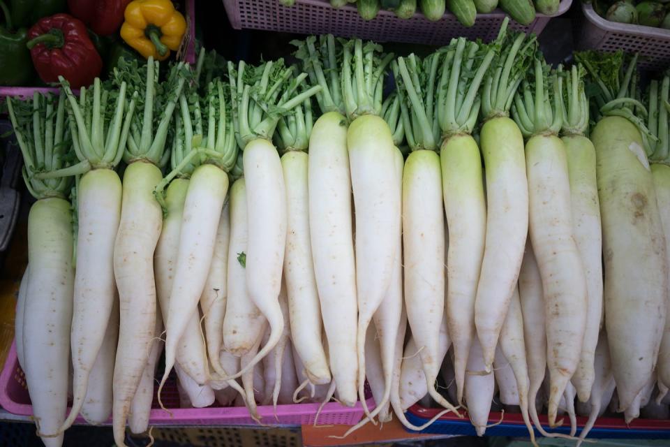 <p>A type of Japanese radish that’s whiter and longer than the red radishes you’re probably familiar with, daikon is used in cooked East Asian dishes, as well as pickled. It has a high water content and is a <a href="https://fdc.nal.usda.gov/fdc-app.html#/food-details/1103565/nutrients" rel="nofollow noopener" target="_blank" data-ylk="slk:good source of fiber;elm:context_link;itc:0;sec:content-canvas" class="link ">good source of fiber</a> and <a href="https://www.prevention.com/beauty/a20480854/best-vitamin-c-serums/" rel="nofollow noopener" target="_blank" data-ylk="slk:vitamin C;elm:context_link;itc:0;sec:content-canvas" class="link ">vitamin C</a>.</p>