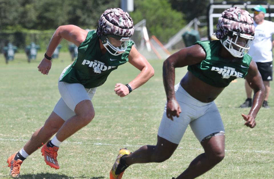 Flagler Palm Coast football players Ashton Bracewell & Rodney Hill,  L/R, sprint across the field, one of many drills, Monday August 1, 2022 during practice.