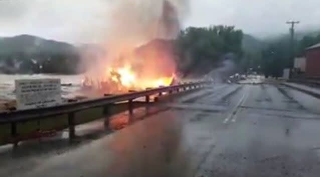 The burning house was washed away in the flooding creek. Source: AMHQ