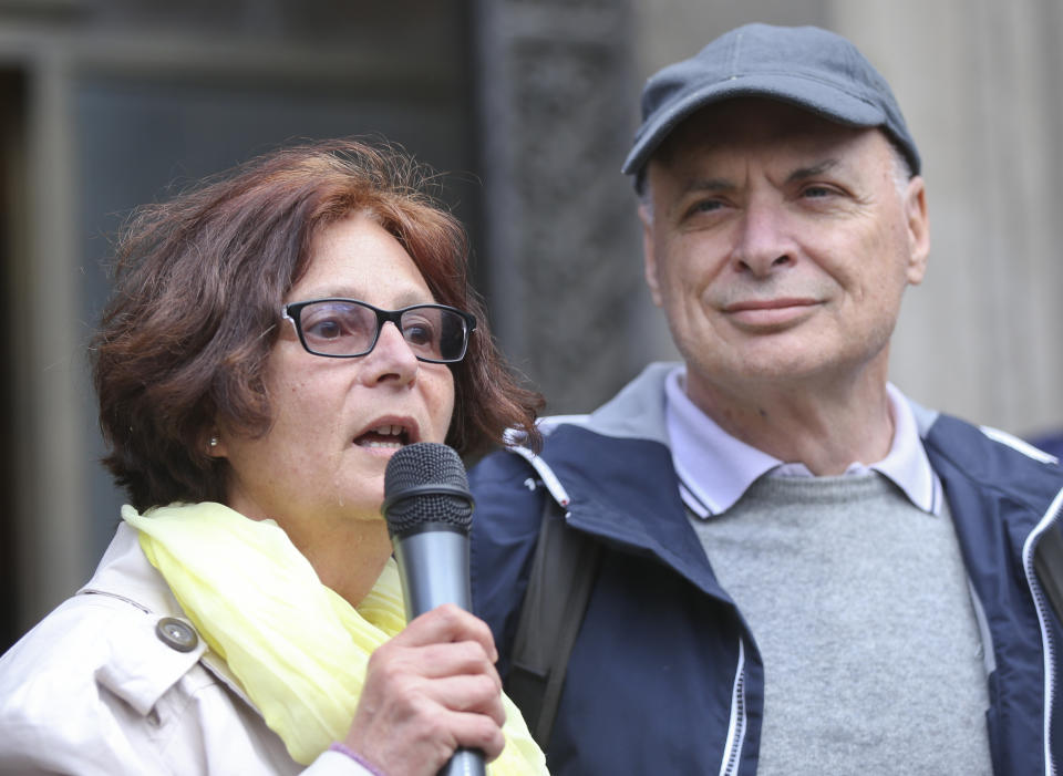 FILE - In this April 24, 2016 file photo, Paola, left, mother of slain student Giulio Regeni, flanked by her husband Claudio, speaks during a flash mob in Milan, Italy, Sunday, April 24, 2016, organized by Amnesty International and asking for truth on their son's death in January 2016 in Egypt. Four high-level Egyptian security officials are going on trial Tuesday, Feb. 20, 2024, in absentia in a Rome court, accused in the 2016 abduction, torture and slaying of an Italian doctoral student in Cairo. (AP Photo/Luca Bruno, file)