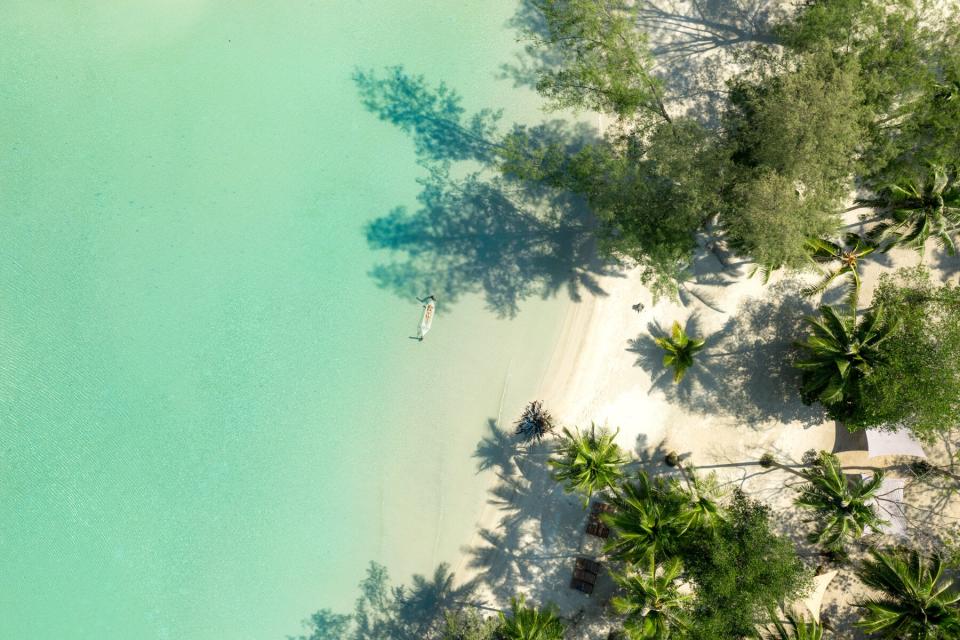 Aerial view of a woman on the beach at Soneva Kiri