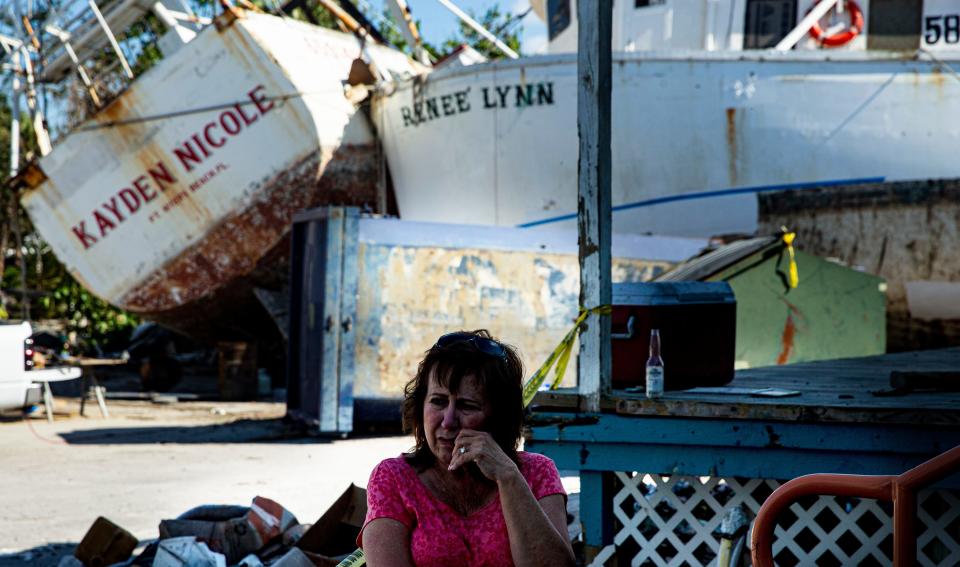 Chris Gala, a part owner of Trico Shrimp Company, visits the business at the Fort Myers Beach shrimp docks on Dec,  6, 2022. Her business has been at a standstill since it was decimated by Hurricane Ian. She is hopeful for the future of the business.