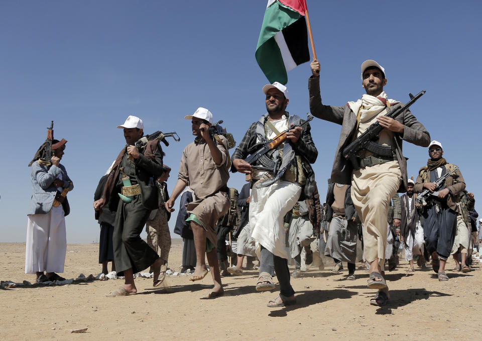 File - Houthi fighters march during a rally of support for the Palestinians in the Gaza Strip and against the U.S. strikes on Yemen outside Sanaa on Jan. 22, 2024. Attacks on ships in the Red Sea by Houthi rebels have unraveled a key global trade route, forcing vessels into longer and more costly journeys around Africa. (AP Photo)