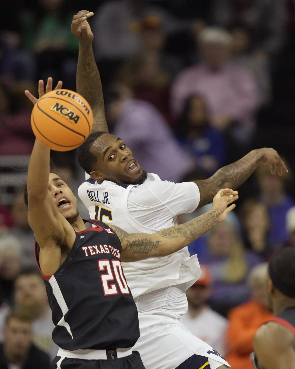 Texas Tech guard Jaylon Tyson (20) beats West Virginia forward Jimmy Bell Jr. (15) to a rebound during the first half of an NCAA college basketball game in the first round of the Big 12 Conference tournament Wednesday, March 8, 2023, in Kansas City, Mo. (AP Photo/Charlie Riedel)