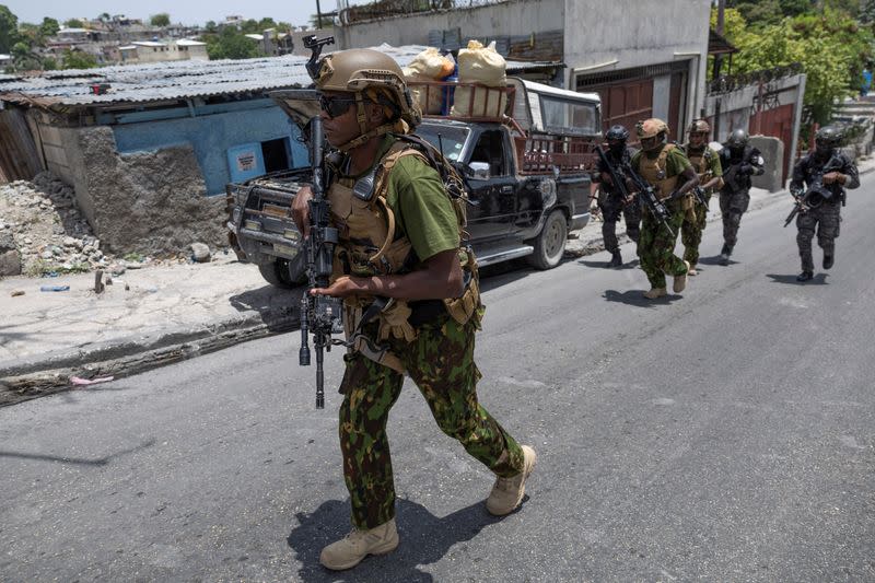 Kenyan police and Haitian National police SWAT units patrol streets in armoured vehicles, in Port-au-Prince