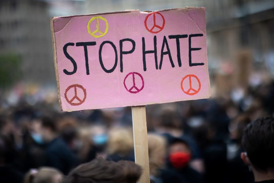 Participants in a June 2020 demonstration against racism and police violence protest with a sign saying “Stop Hate” on the town hall market in Hamburg, Germany. (Photo by Christian Charisius/picture alliance via Getty Images)