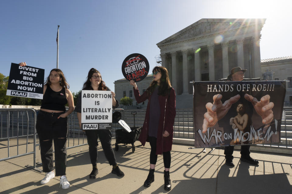 Anti-abortion and abortion-rights protesters gather outside the U.S. Supreme Court, Wednesday, April 19, 2023, in Washington. (AP Photo/Manuel Balce Ceneta)