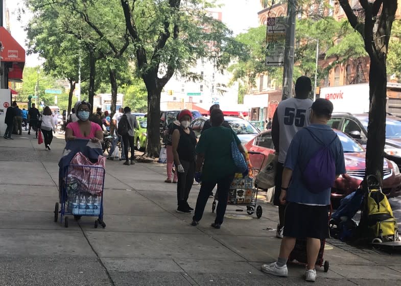 The line for food at the Community Kitchen and Pantry in Harlem stretched down the block of West 116th Street. (Photo by Vera Haller) (taken on 07/13/2020)