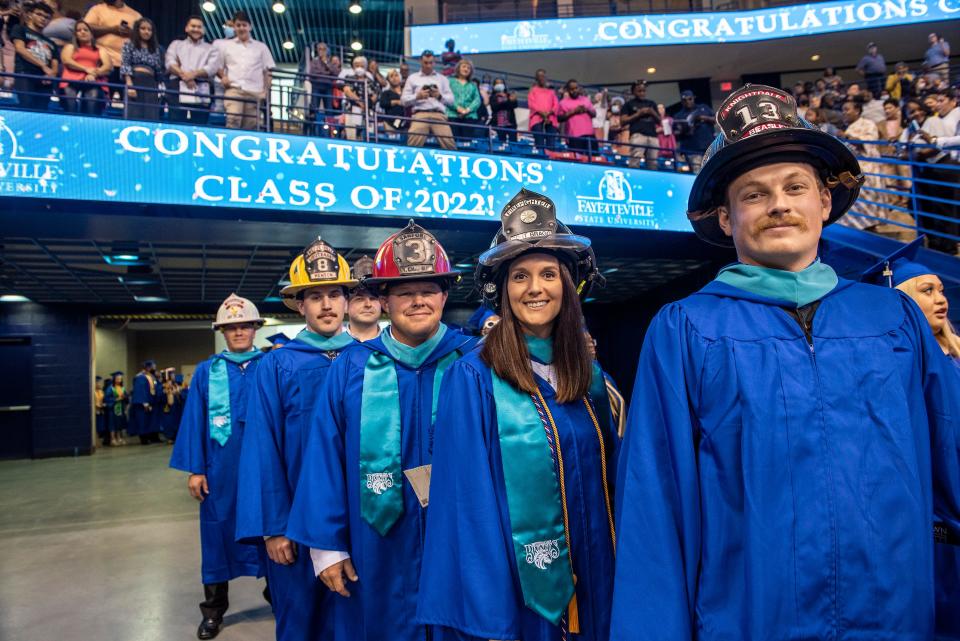 Front to back, Adam M. Beasley, Stacey A. Palmiter, Brandon A. Chapman and Clint T. Henson. The four were among several who received their bachelor's degrees in Fire and Emergency Services Administration at Fayetteville State University's spring commencement on Saturday, May 7, 2022, at Crown Coliseum.