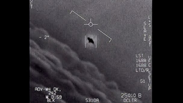 PHOTO: The image from video provided by the Department of Defense labelled Gimbal, from 2015, an unexplained object is seen at center as it is tracked as it soars high along the clouds, traveling against the wind. (Department of Defense via AP)