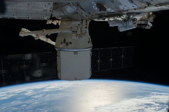 A Dragon capsule attached to the International Space Station.